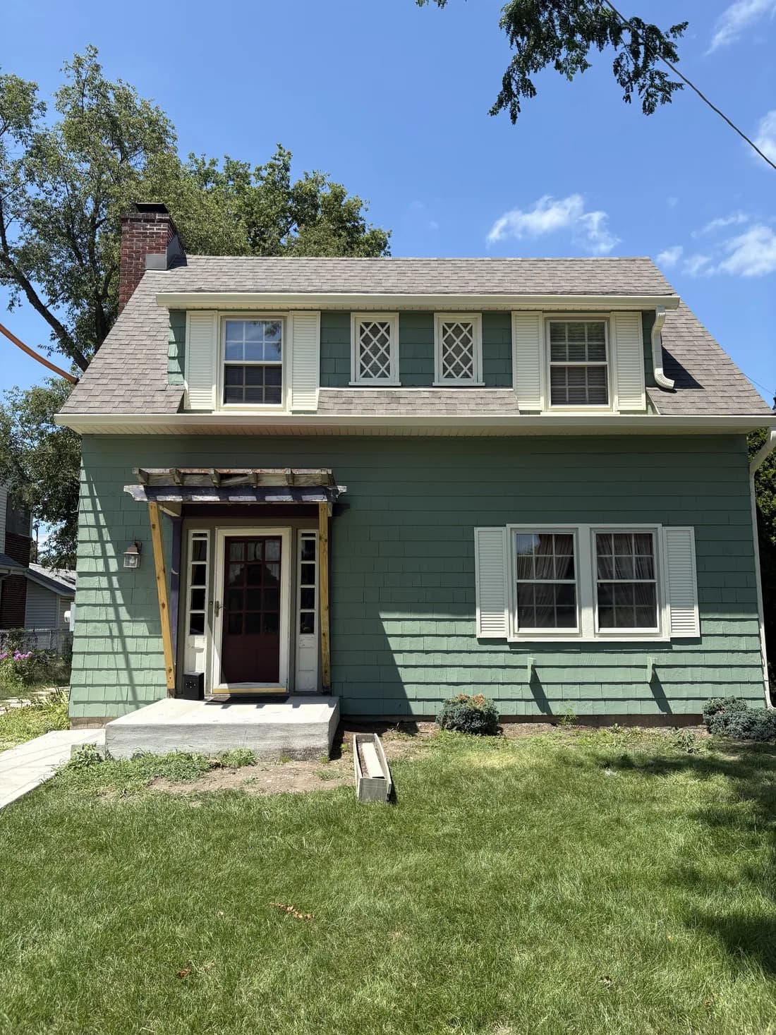 Exterior repaint — fresh green siding with clean white trim