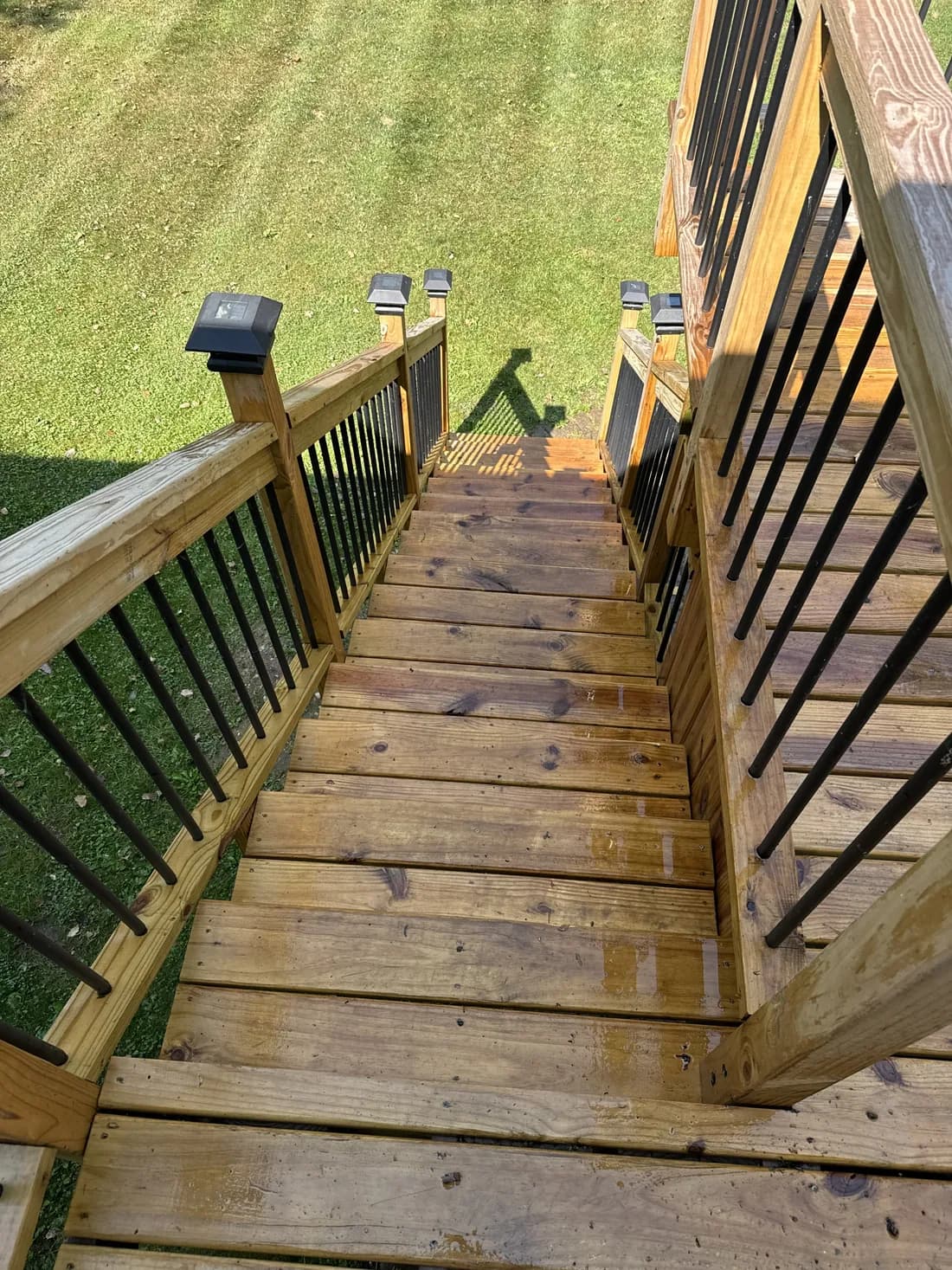 Deck mid-pressure-wash — years of grime lifted from the wood